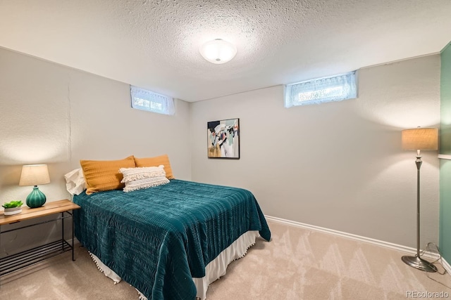 carpeted bedroom with multiple windows and a textured ceiling