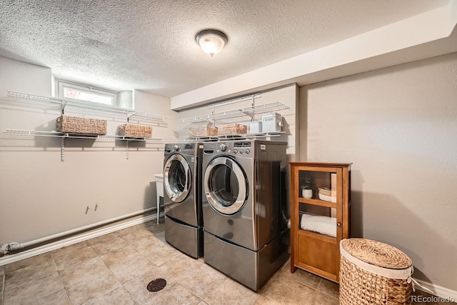 laundry area featuring washer and dryer and a textured ceiling