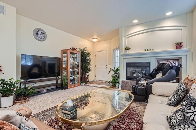 living room featuring recessed lighting, visible vents, and a glass covered fireplace