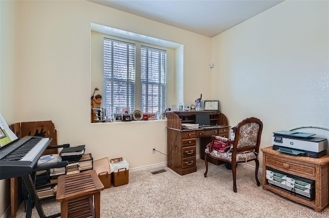 carpeted office space with visible vents and baseboards