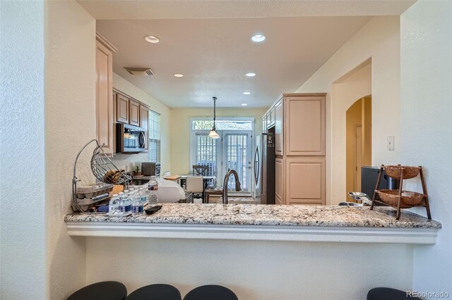 kitchen with visible vents, arched walkways, appliances with stainless steel finishes, a sink, and recessed lighting