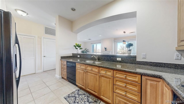 2500 E Cherry Creek S Drive 213, Denver, CO 80209 - kitchen with black appliances, a sink, arched walkways, and dark stone counters