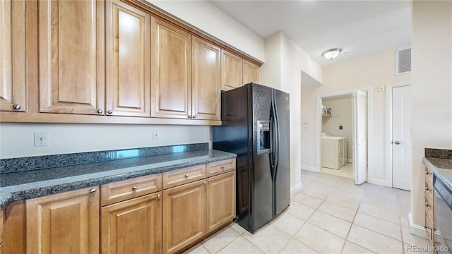 2500 E Cherry Creek S Drive 213, Denver, CO 80209 - kitchen featuring black fridge with ice dispenser, washer / dryer, light tile patterned flooring, baseboards, and brown cabinets
