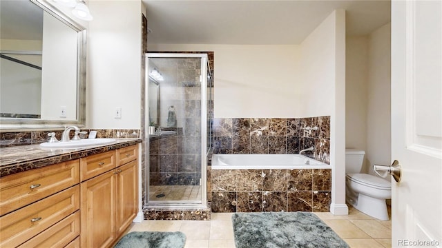 2500 E Cherry Creek S Drive 213, Denver, CO 80209 - full bath featuring vanity, tile patterned flooring, toilet, a bath, and a stall shower