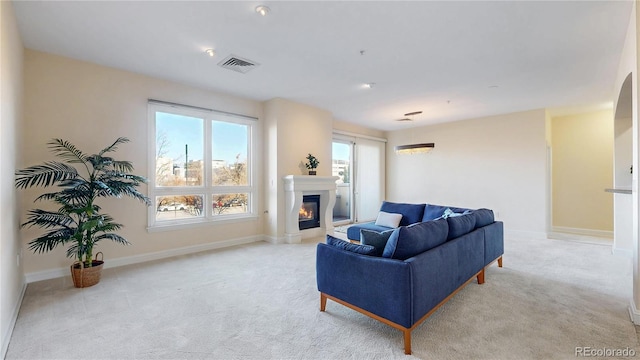2500 E Cherry Creek S Drive 213, Denver, CO 80209 - living room with light carpet, a glass covered fireplace, and baseboards