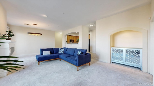 2500 E Cherry Creek S Drive 213, Denver, CO 80209 - living room featuring carpet floors, baseboards, and arched walkways