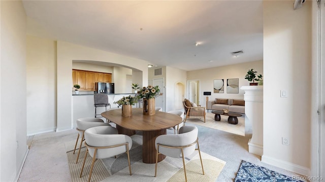 2500 E Cherry Creek S Drive 213, Denver, CO 80209 - dining area featuring arched walkways, light carpet, and baseboards
