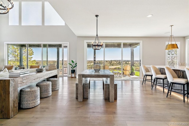 dining area featuring an inviting chandelier and hardwood / wood-style floors