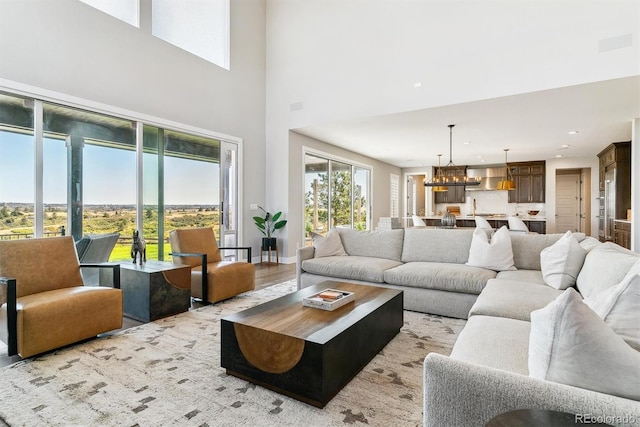 living room with an inviting chandelier and light wood-type flooring