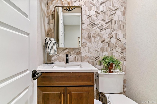 bathroom with tasteful backsplash, vanity, and toilet