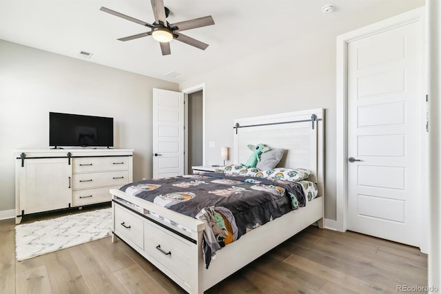 bedroom with hardwood / wood-style floors and ceiling fan