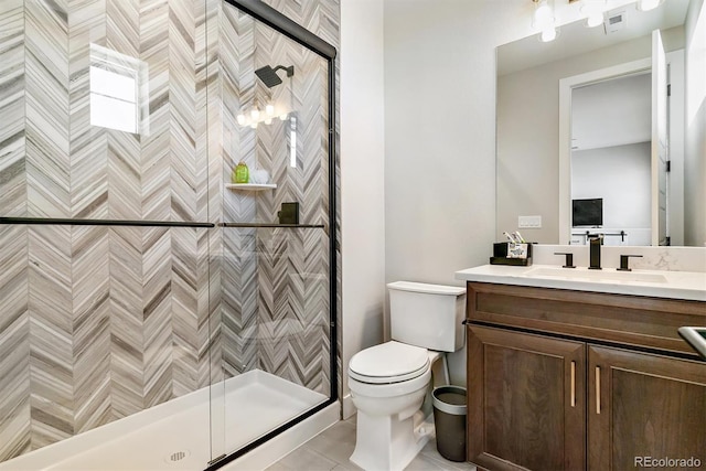 bathroom featuring a shower with door, vanity, and toilet