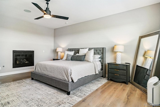 bedroom with ceiling fan and light hardwood / wood-style floors