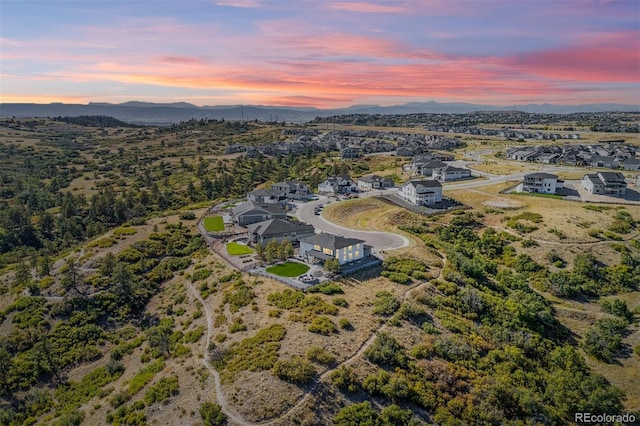 aerial view at dusk featuring a mountain view