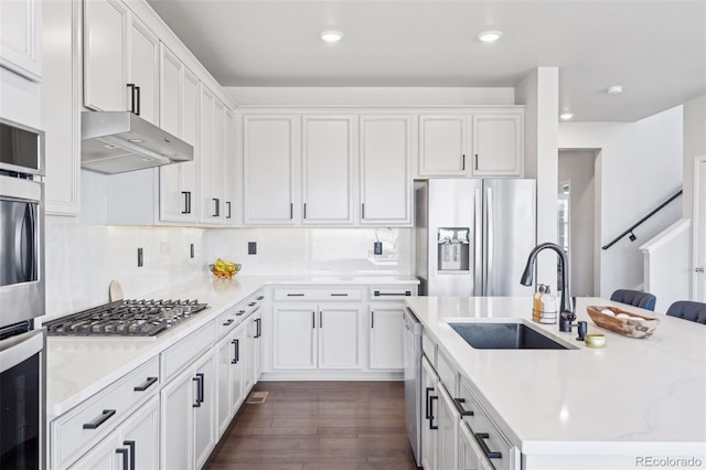 kitchen with appliances with stainless steel finishes, white cabinetry, and under cabinet range hood