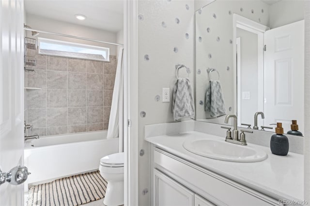 bathroom featuring shower / bath combo, vanity, and toilet