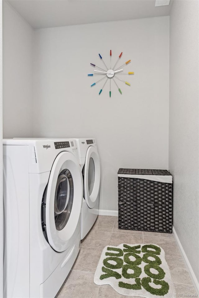 washroom featuring laundry area, independent washer and dryer, and baseboards