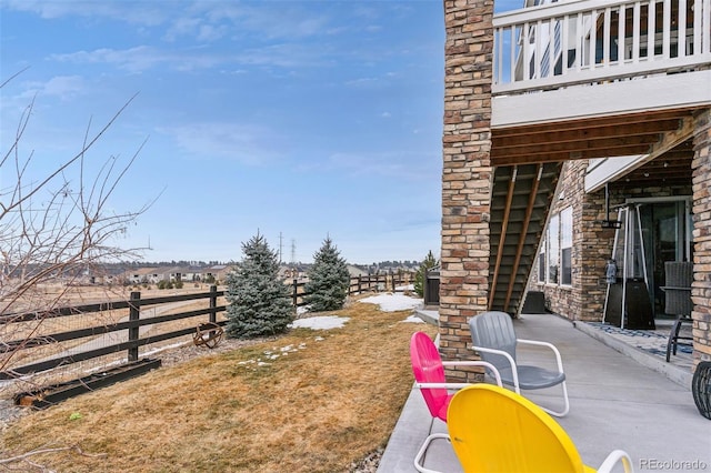 view of yard with a patio area, a fenced backyard, and a balcony