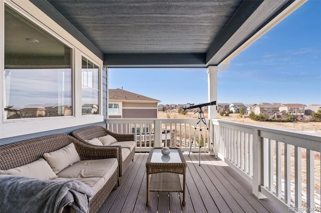 deck featuring an outdoor hangout area and a residential view