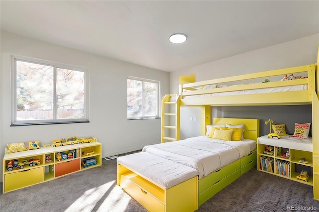 carpeted bedroom featuring a baseboard heating unit