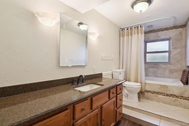 bathroom with tile patterned floors, toilet, vanity, and tiled shower / bath combo