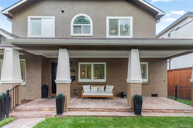 1366 S Vine St, Denver, CO 80210 - view of front facade with brick siding, covered porch, and stucco siding