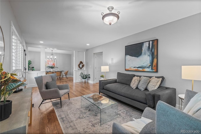 1366 S Vine St, Denver, CO 80210 - living area with a chandelier, wood finished floors, recessed lighting, and baseboards