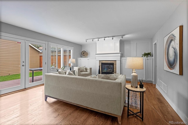 1366 S Vine St, Denver, CO 80210 - living room featuring a glass covered fireplace and wood finished floors