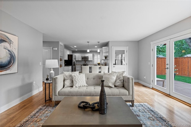1366 S Vine St, Denver, CO 80210 - living room featuring baseboards, light wood-style floors, french doors, and recessed lighting