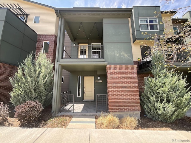 11267 Central Ct, Broomfield, CO 80021 - view of front of property with brick siding and a balcony