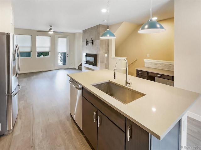 11267 Central Ct, Broomfield, CO 80021 - kitchen featuring stainless steel appliances, open floor plan, light wood-type flooring, and light countertops