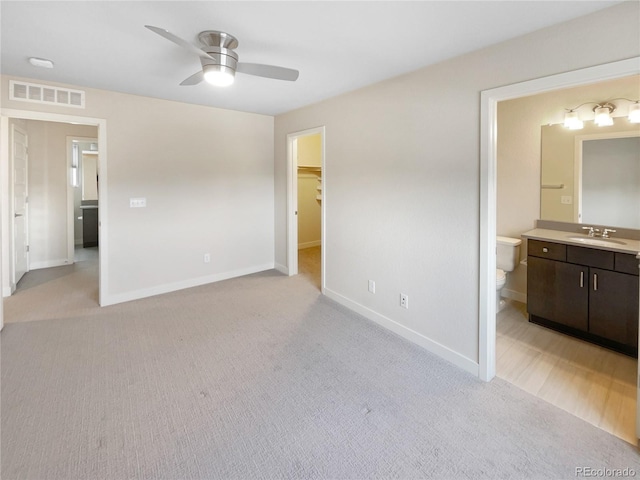 11267 Central Ct, Broomfield, CO 80021 - unfurnished bedroom with light colored carpet, a walk in closet, connected bathroom, and ceiling fan