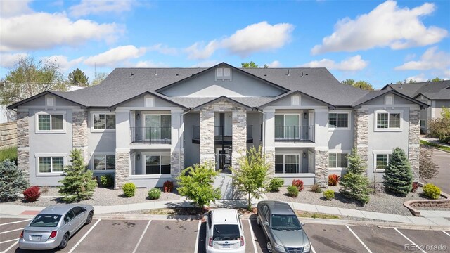 875 E 78th Ave Unit 52, Denver, CO 80229 - view of property featuring uncovered parking