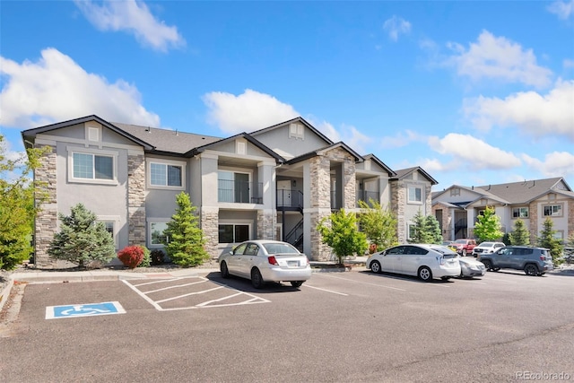 875 E 78th Ave Unit 52, Denver, CO 80229 - view of building exterior featuring uncovered parking and a residential view