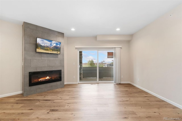 875 E 78th Ave Unit 52, Denver, CO 80229 - unfurnished living room with a fireplace, wood finished floors, recessed lighting, and baseboards