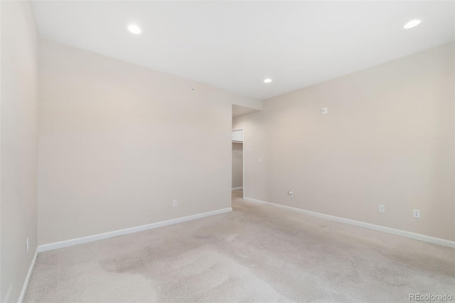 875 E 78th Ave Unit 52, Denver, CO 80229 - unfurnished room with light colored carpet, baseboards, and recessed lighting