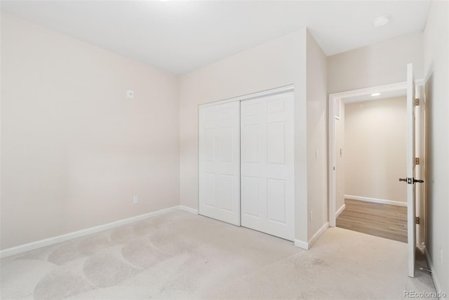 875 E 78th Ave Unit 52, Denver, CO 80229 - unfurnished bedroom featuring carpet floors, a closet, and baseboards