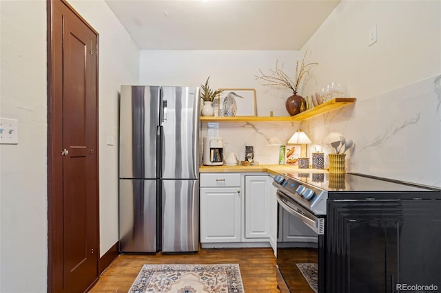 kitchen with decorative backsplash, dark hardwood / wood-style floors, stainless steel fridge, and electric stove