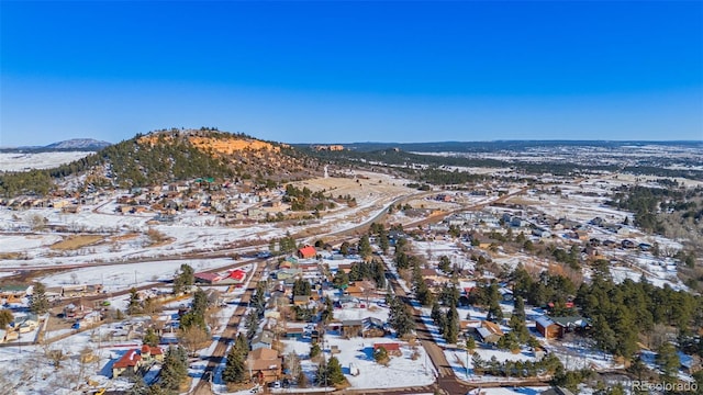 snowy aerial view featuring a mountain view