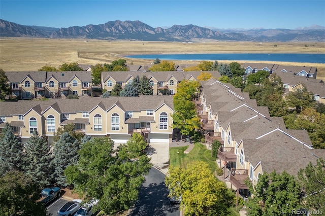 drone / aerial view with a water and mountain view