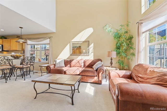 living room featuring a wealth of natural light and light colored carpet