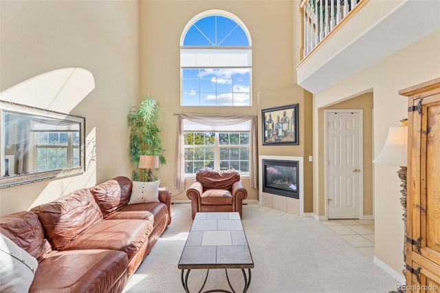 living room featuring light carpet and a towering ceiling