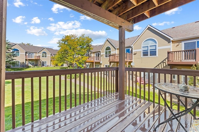 wooden deck with a lawn