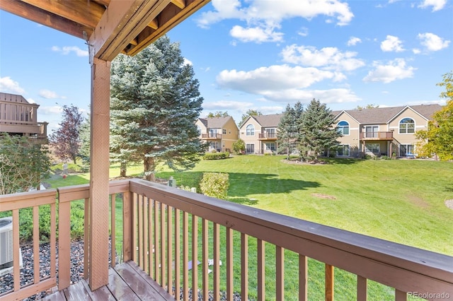 wooden deck featuring a yard