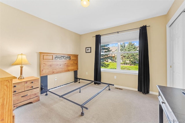 carpeted bedroom with a closet