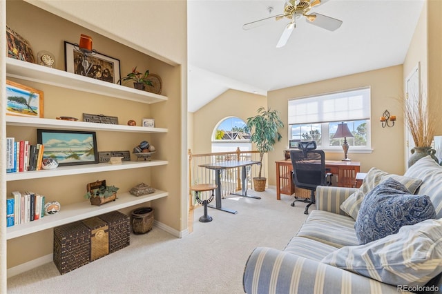 interior space featuring lofted ceiling, ceiling fan, and light colored carpet