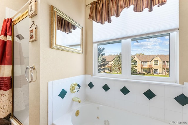 bathroom featuring independent shower and bath and plenty of natural light