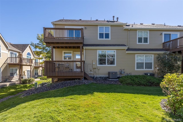 back of house featuring a lawn, a wooden deck, and central AC unit