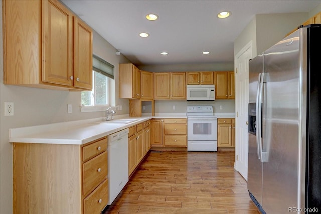 2253 E 100th Pl, Thornton, CO 80229 - kitchen with white appliances, light wood finished floors, recessed lighting, a sink, and light brown cabinets
