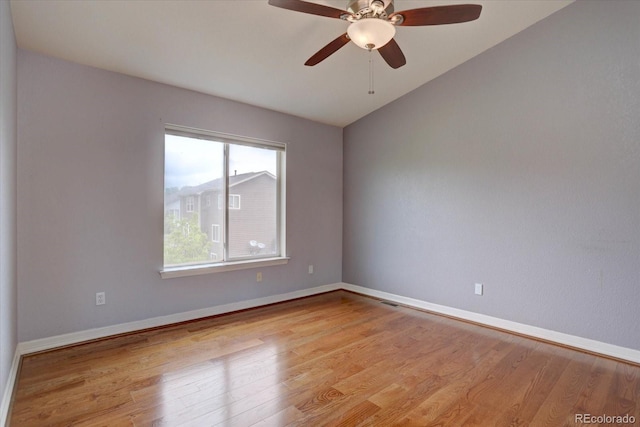 2253 E 100th Pl, Thornton, CO 80229 - spare room with wood finished floors, ceiling fan, baseboards, and vaulted ceiling